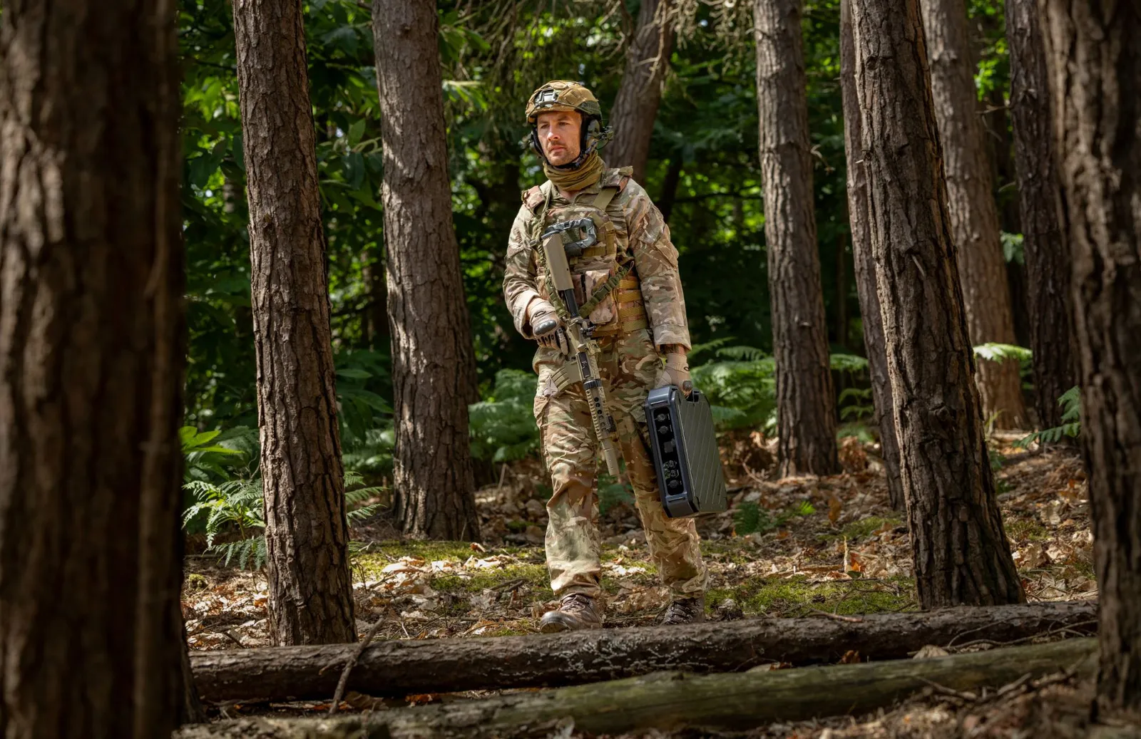 Soldier walking through woodland carrying the RBK case